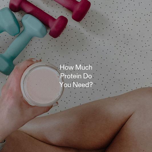 Hand holding protein shake with dumbbells in background, symbolizing strength training and optimal protein intake for weight loss