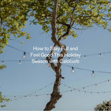 Tree under string lights on a sunny day, symbolizing a calm and mindful holiday season with Calocurb support