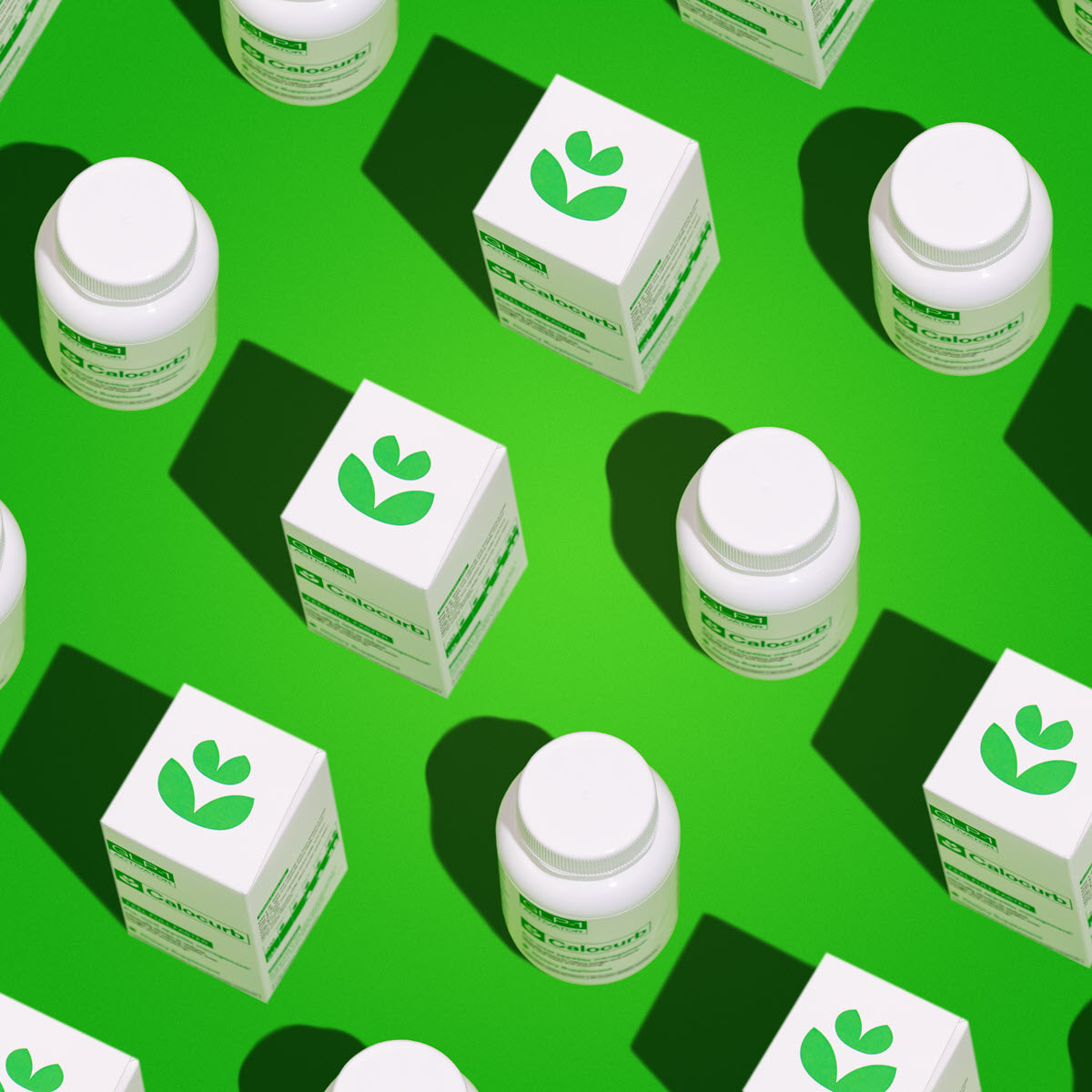 White bottles and boxes with green leaves on a green background
